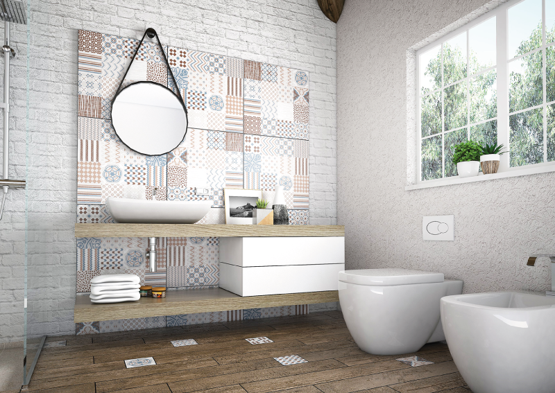 a white brick wall in a bathroom with patterned tiles over it